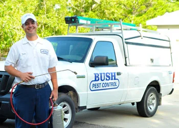 Bush Pest Control Technician standing in front of truck